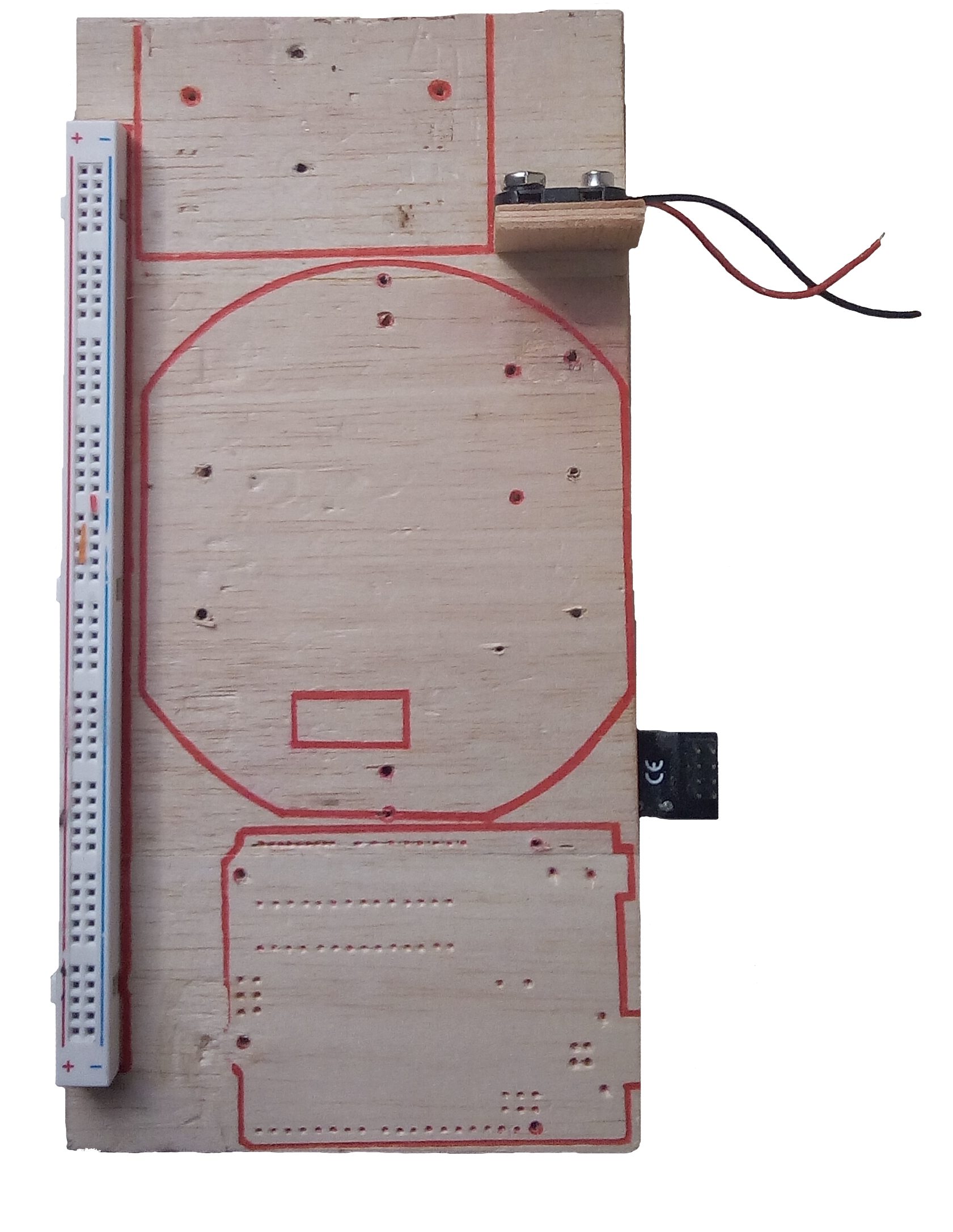 The plywood base board with the component layout drawn in marker and a breadboard attached