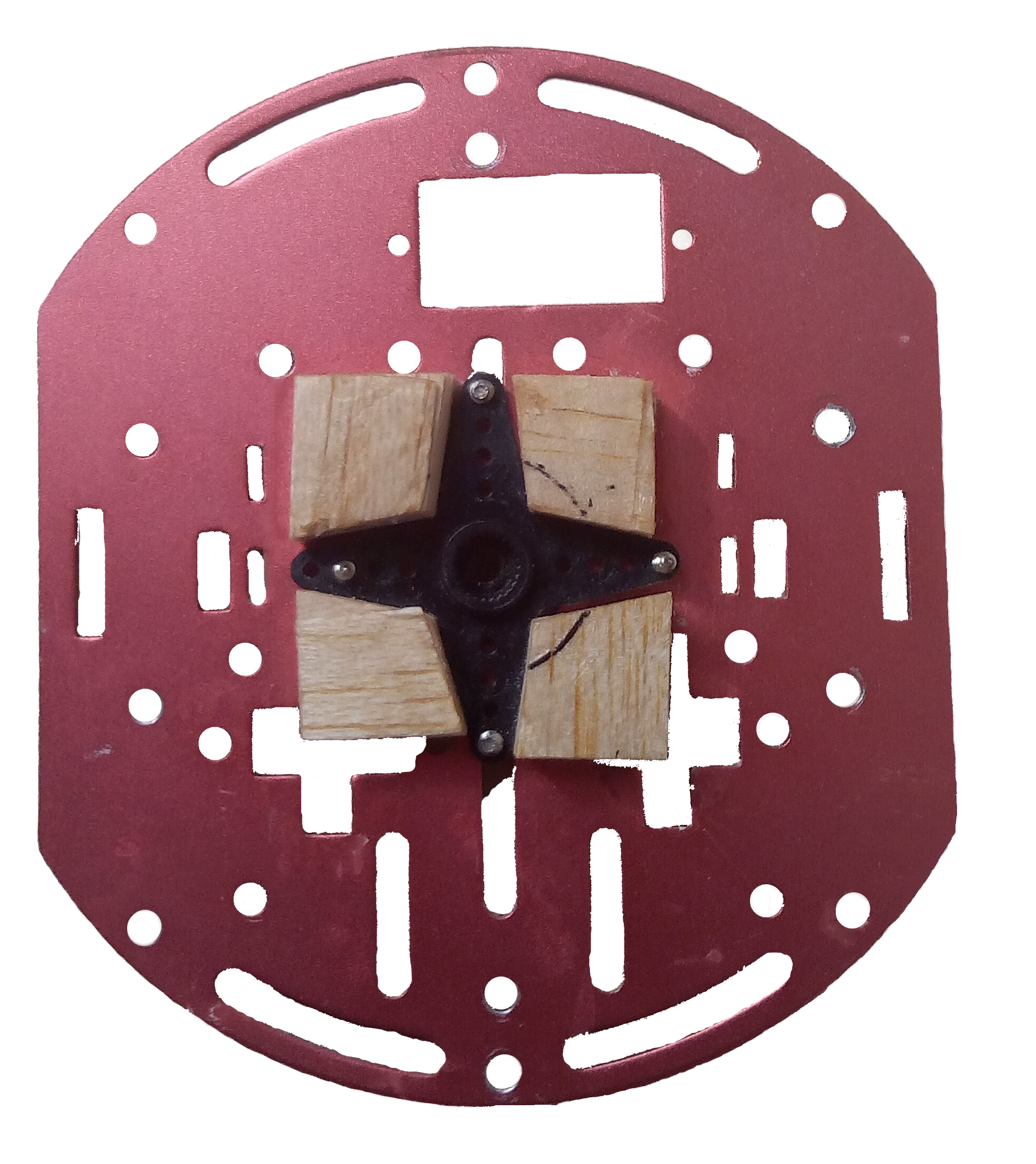 The metal base plate with the servo horn mounted between balsa blocks