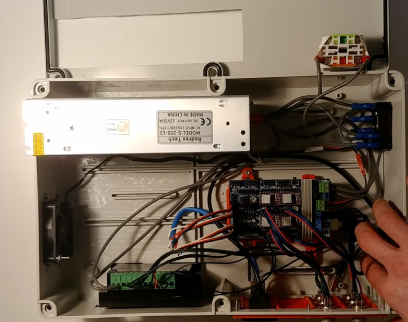 The open control box: 12 V 20 A power supply, Arduino with RAMPS board and DRV8825 drivers, the base motor's driver, fan and terminal blocks