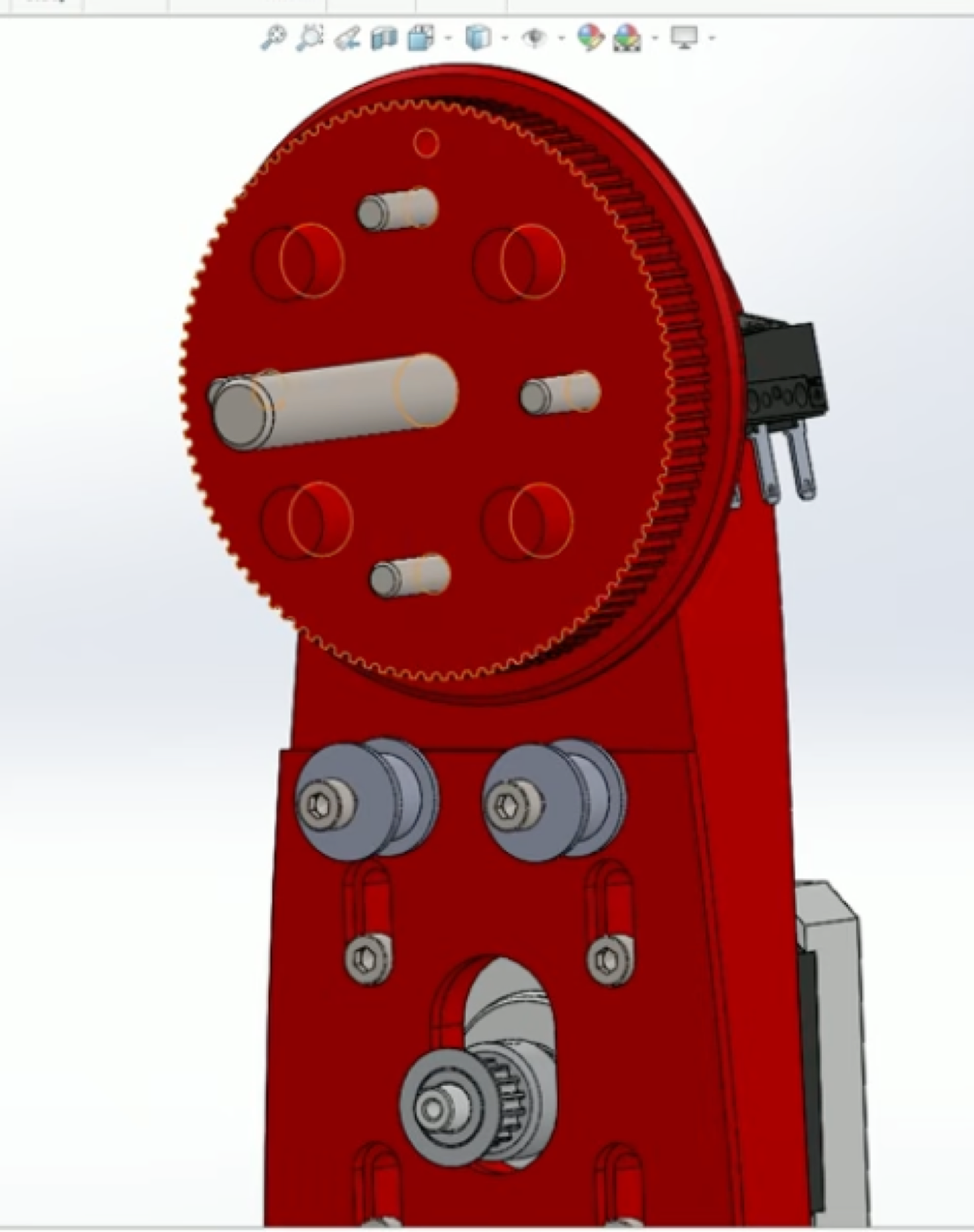 CAD front view of the elbow joint: 100-tooth pulley, two adjustable idlers, motor pulley below